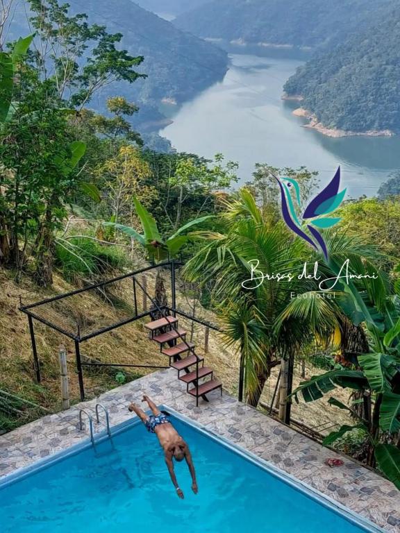 a swimming pool with a view of a river at EcoHotel Brisas del Amani in Norcasia
