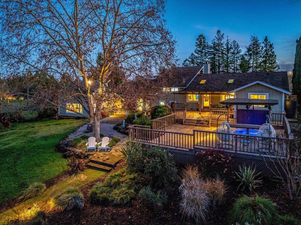 a large house with a deck and a yard at Serenity On Dragonfly A Wine Country Escape in Healdsburg