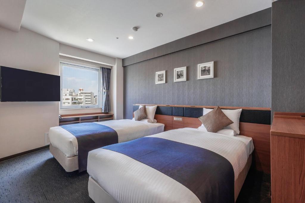 Postel nebo postele na pokoji v ubytování HOTEL MYSTAYS Nagoya Sakae