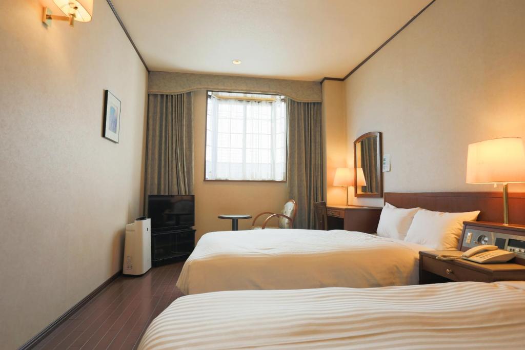 Postel nebo postele na pokoji v ubytování Hotel Castle Inn Suzuka