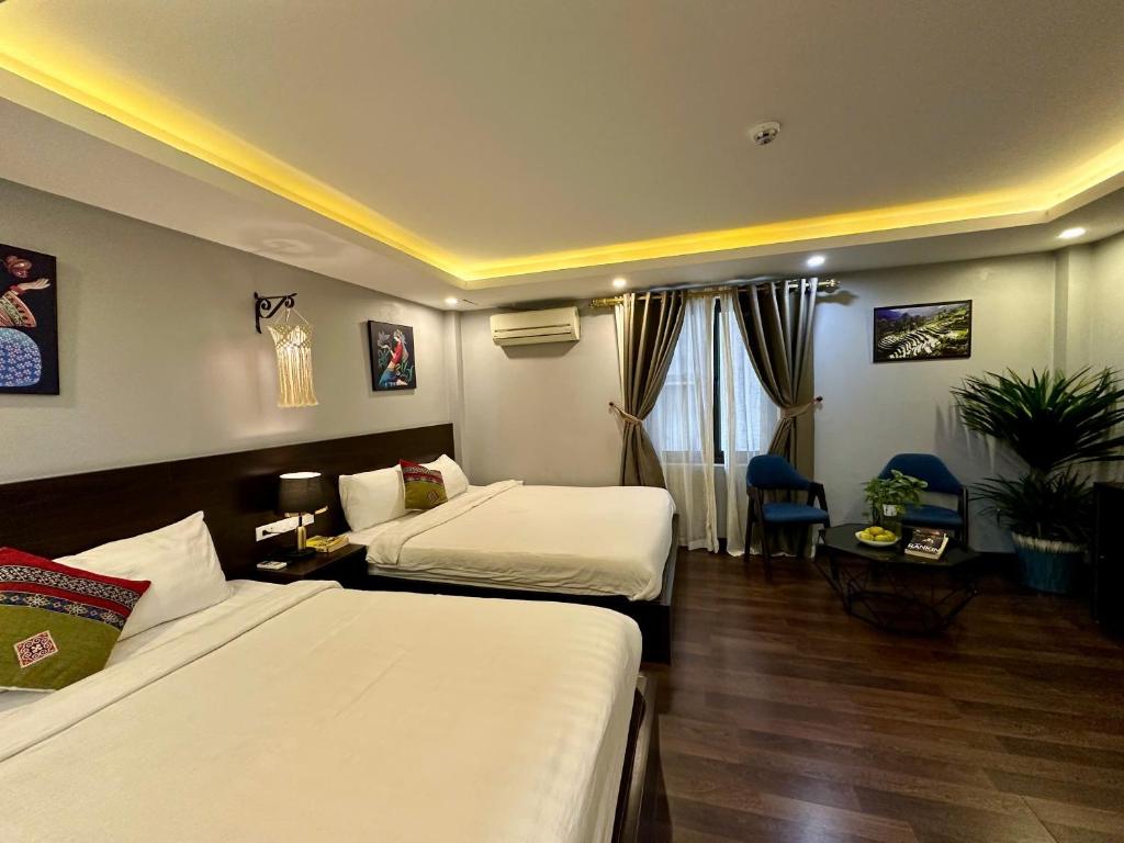 Postel nebo postele na pokoji v ubytování HeLLo Sapa Hotel