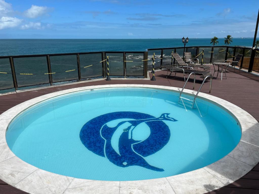 a swimming pool with a dolphin painted on it at Pier Sul Apart Service in Salvador