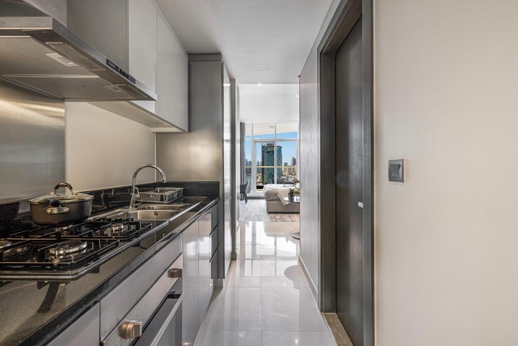 a kitchen with a sink and a stove at Livin' Holidays - Luxury studio with Bay view in Dubai