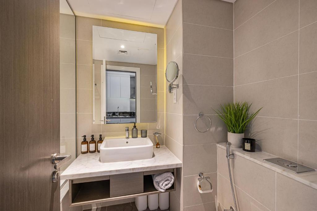 a bathroom with a sink and a mirror at Livin' Holidays - Luxury studio with Bay view in Dubai