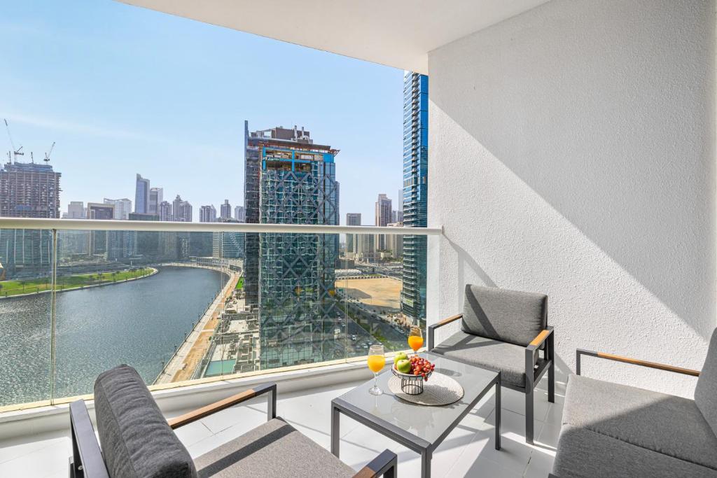 a room with a balcony with a view of a city at Livin' Holidays - Luxury studio with Bay view in Dubai
