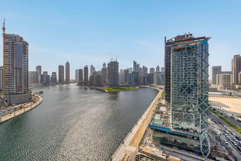 a view of a river in a city with buildings at Livin' Holidays - Luxury studio with Bay view in Dubai