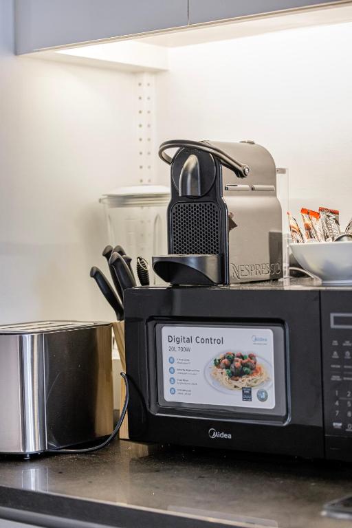 a microwave sitting on top of a kitchen counter at Livin' Holidays - Luxury studio with Bay view in Dubai