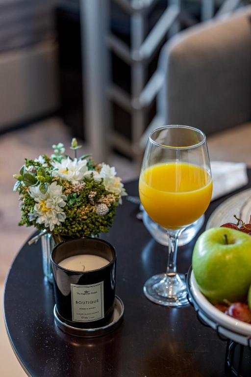 a table with a glass of orange juice and a plate of fruit at Livin' Holidays - Luxury studio with Bay view in Dubai