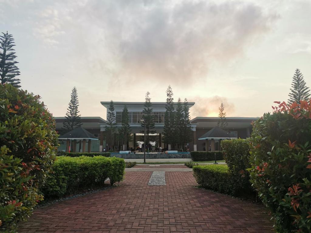 a building with a brick walkway in front of it at Cool Suites SMDC Tagaytay in Tagaytay