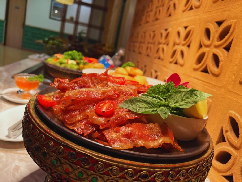 a plate of food on a table with food at Villa Sirilanna Hotel in Chiang Mai