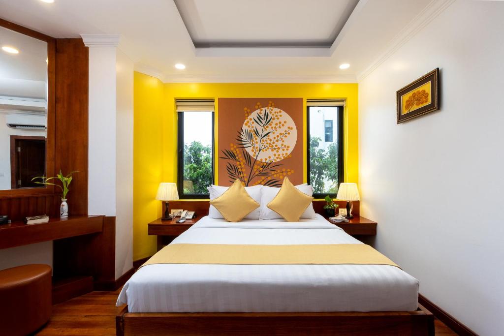 Postel nebo postele na pokoji v ubytování Le Vert Angkor Hotel