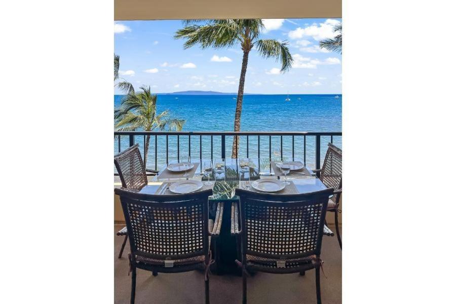 a table on a balcony with a view of the ocean at SUGAR BEACH RESORT, #540 condo in Kihei