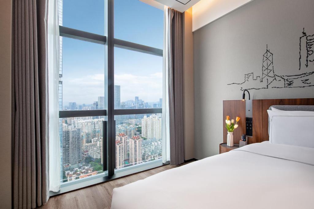 Postel nebo postele na pokoji v ubytování UrCove by Hyatt Shenzhen Bay Nanyou