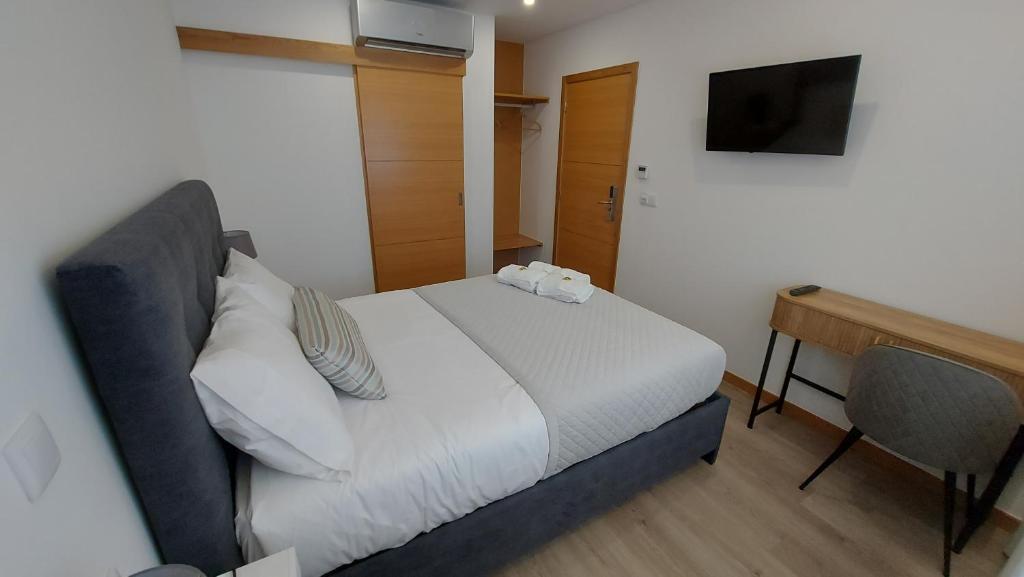 Postel nebo postele na pokoji v ubytování DiROMANE