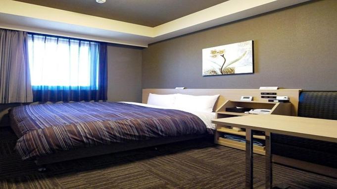 Postel nebo postele na pokoji v ubytování Hotel Route-Inn Shimizu Inter
