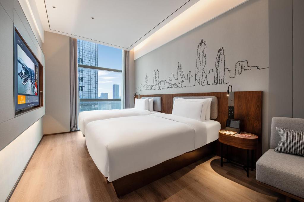 Postel nebo postele na pokoji v ubytování UrCove by Hyatt Shenzhen Bay Nanyou