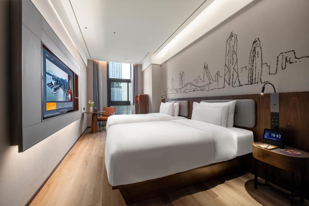 Postel nebo postele na pokoji v ubytování UrCove by Hyatt Shenzhen Bay Nanyou