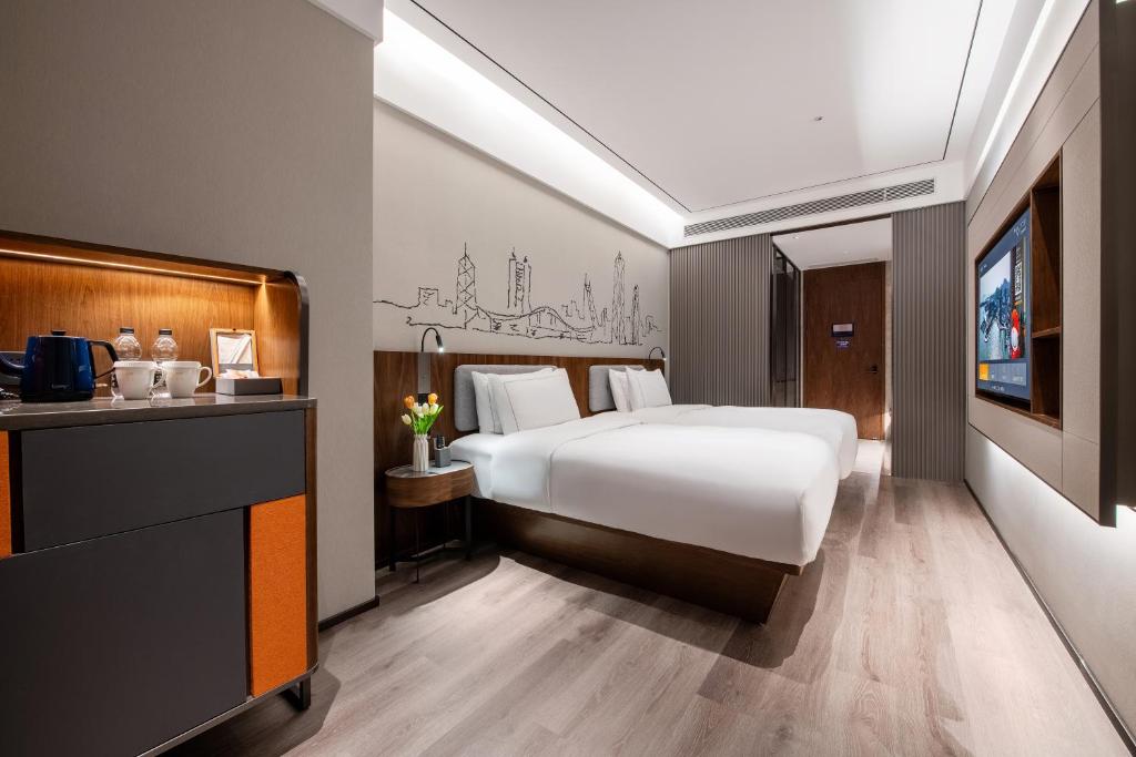 Postel nebo postele na pokoji v ubytování UrCove by Hyatt Shenzhen Bay Nanyou
