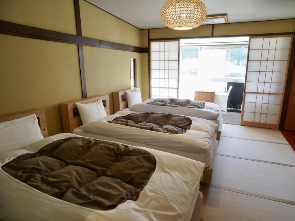 Voodi või voodid majutusasutuse 桜 River Side Stay下呂温泉 toas