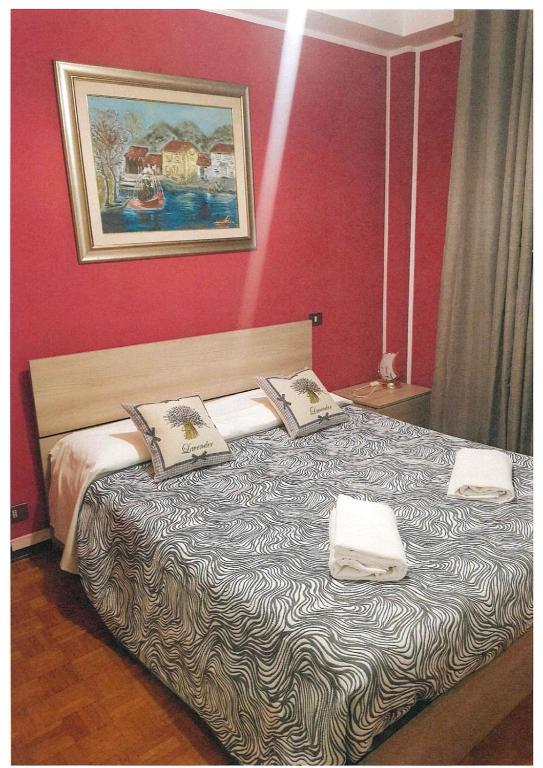 a bedroom with a large bed with two pillows at Baraka Guest House Venice in Mestre