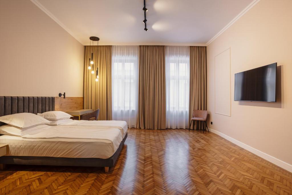 Postel nebo postele na pokoji v ubytování Bloom Downtown Suites
