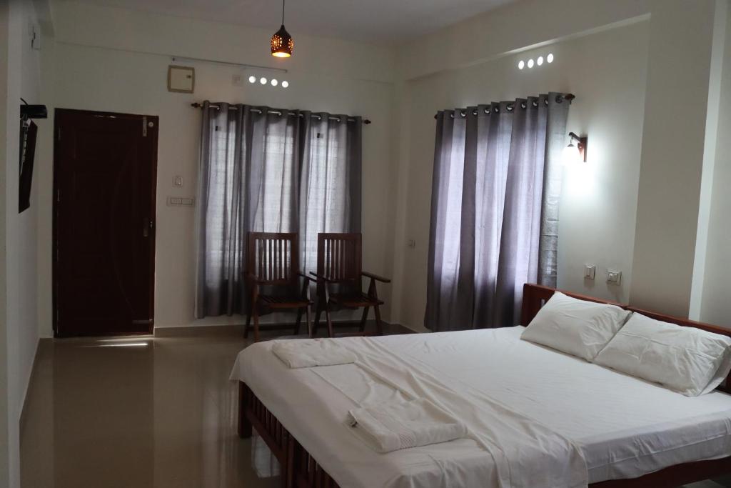Postelja oz. postelje v sobi nastanitve CHAEL Airport Residency,Nedumbassery Cochin