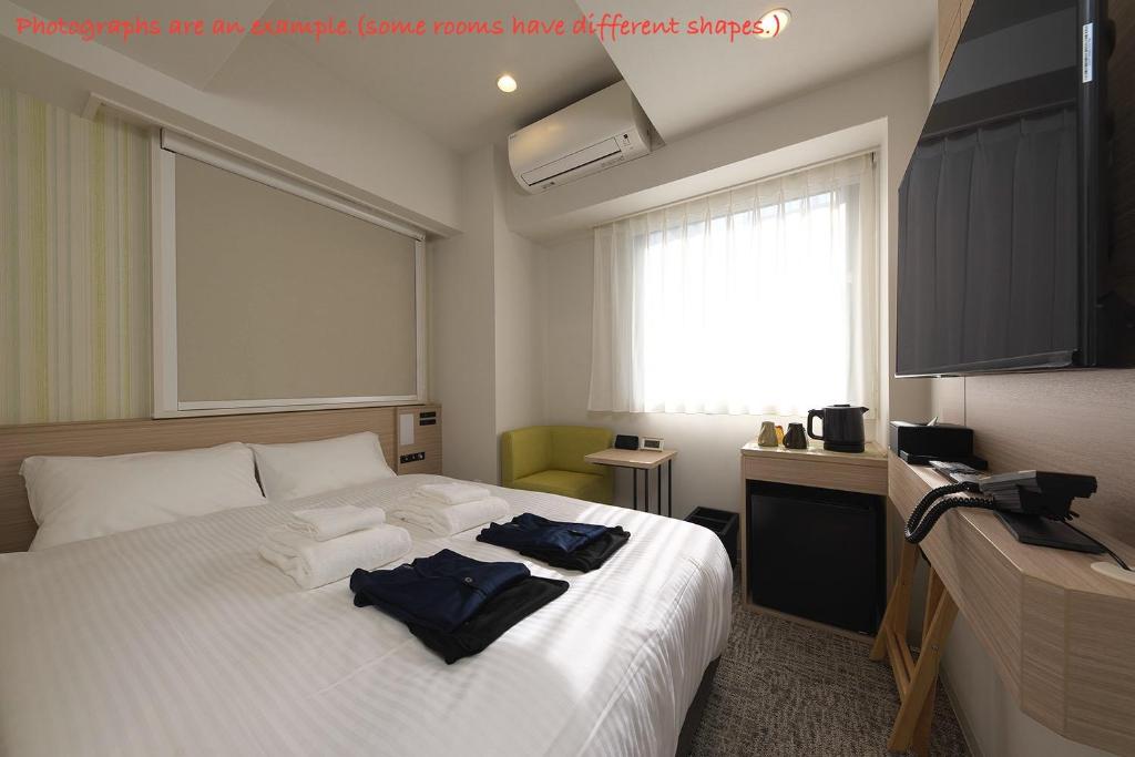 Postel nebo postele na pokoji v ubytování Fourz Hotel Kintetsu Osaka-Namba