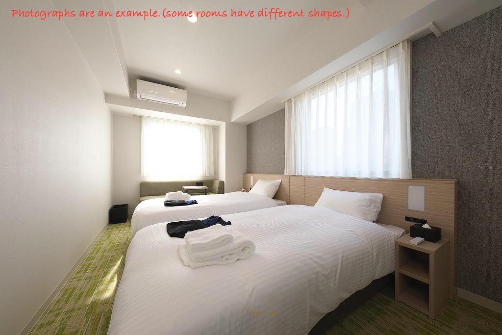 Postel nebo postele na pokoji v ubytování Fourz Hotel Kintetsu Osaka-Namba