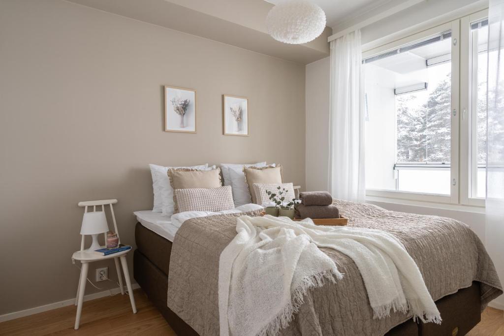 a bedroom with a bed and a window at Frost Lodge Hosted by Hygge Host in Rovaniemi