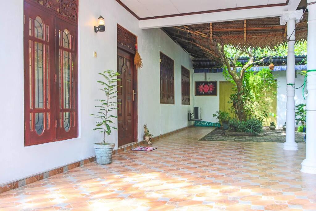a hallway of a house with a potted plant at Lakmali Homestay in Watagederamulla