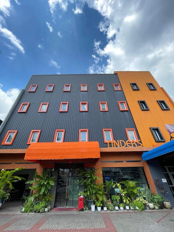 a building with an orange and gray roof at Anders Arjuna Selatan in Jakarta
