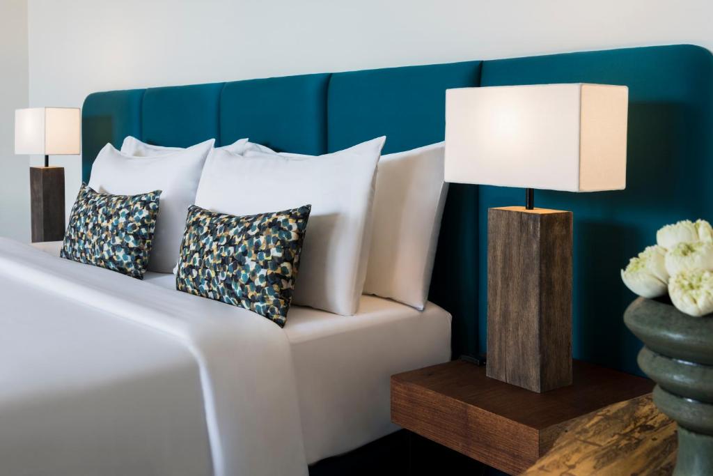 a white couch with pillows and a lamp on a table at Viroth's Hotel in Siem Reap