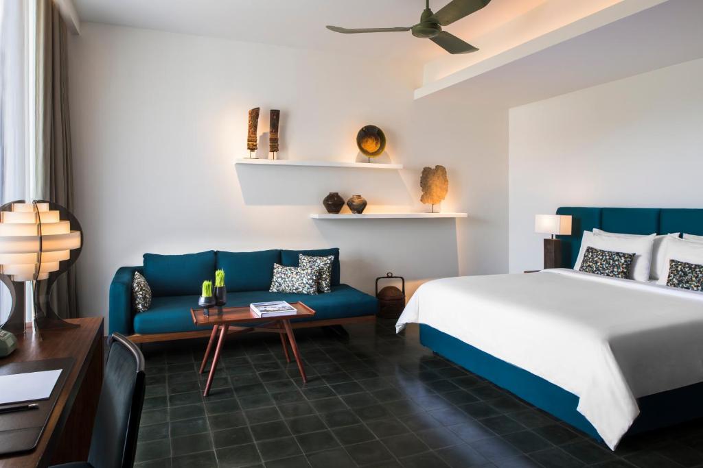 a bedroom with a bed and a couch at Viroth's Hotel in Siem Reap
