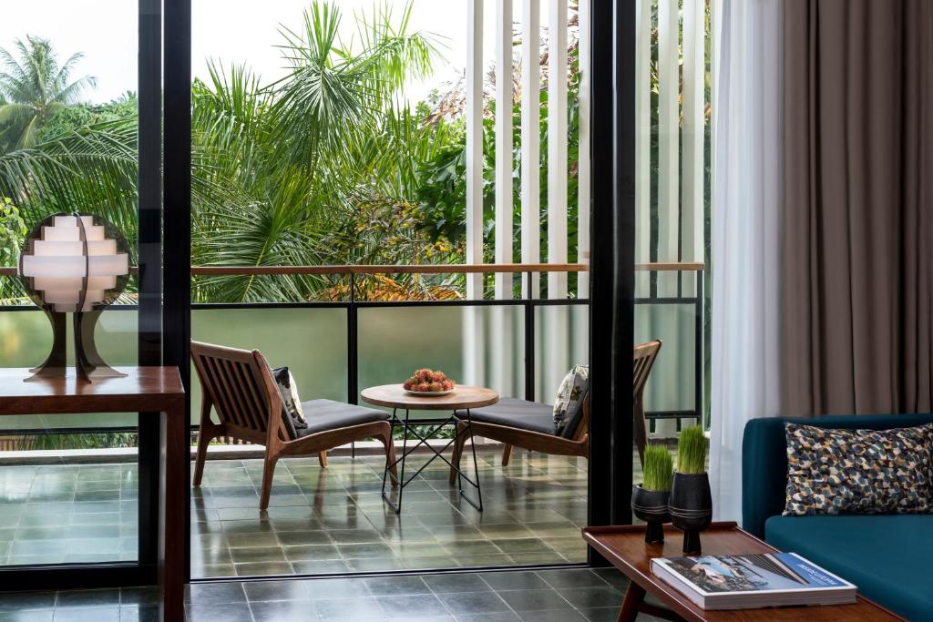 a room with a balcony with a table and chairs at Viroth's Hotel in Siem Reap