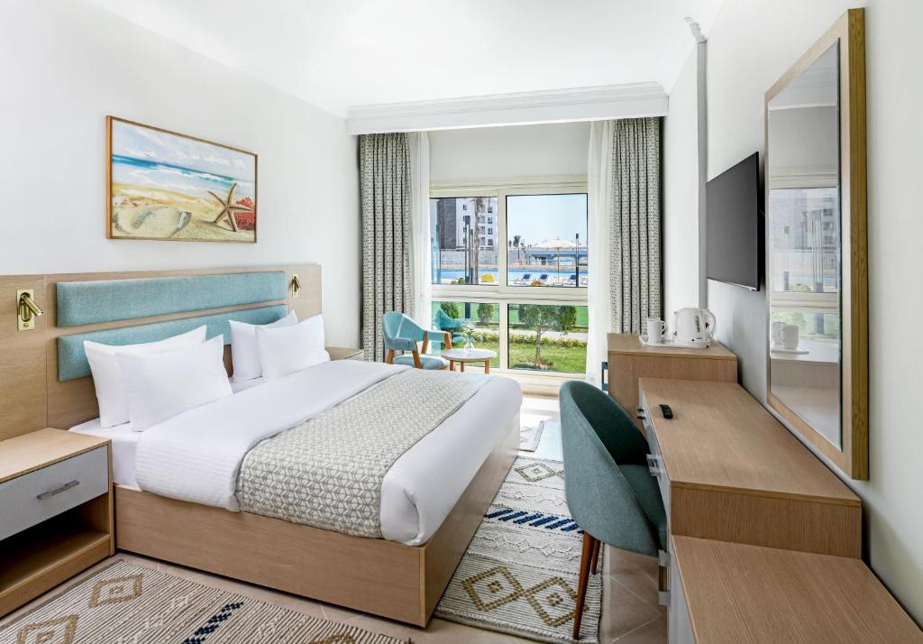 Postel nebo postele na pokoji v ubytování Azur One Eleven Hotel Alamein