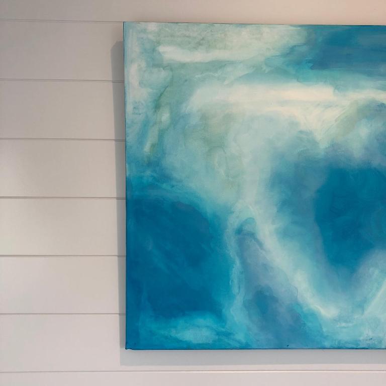 a painting of a cloudy sky on a wall at Sandy Meadow Escapes in Lairg