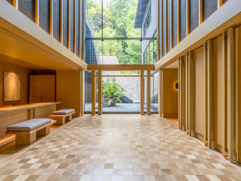 an empty lobby with a large window and benches at Banyan Tree Higashiyama Kyoto in Kyoto