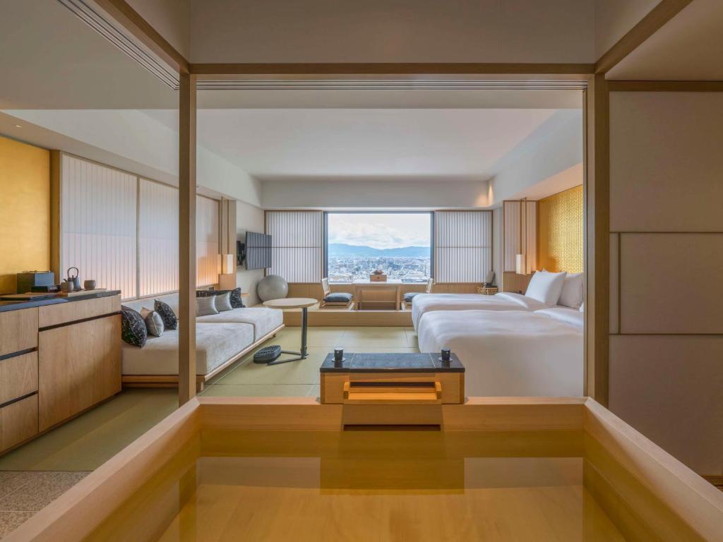 a hotel room with a bed and a living room at Banyan Tree Higashiyama Kyoto in Kyoto