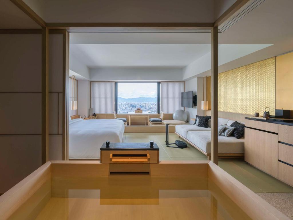 a bedroom with a bed and a living room at Banyan Tree Higashiyama Kyoto in Kyoto