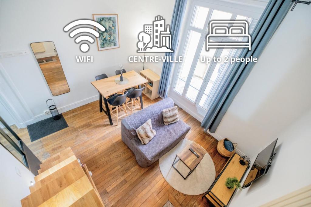 an overhead view of a living room and dining room with a table at Le Brillant - Studio in Reims