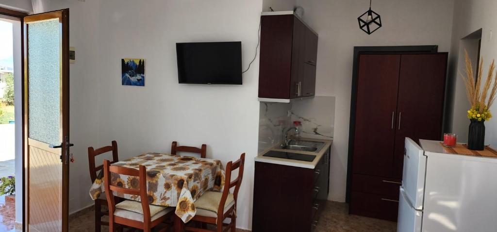 a kitchen with a table and a small kitchen with a sink at Villas Ermali in Ksamil