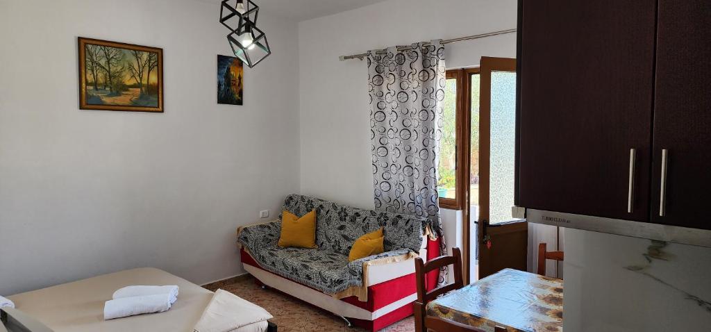 a living room with a chair and a window at Villas Ermali in Ksamil