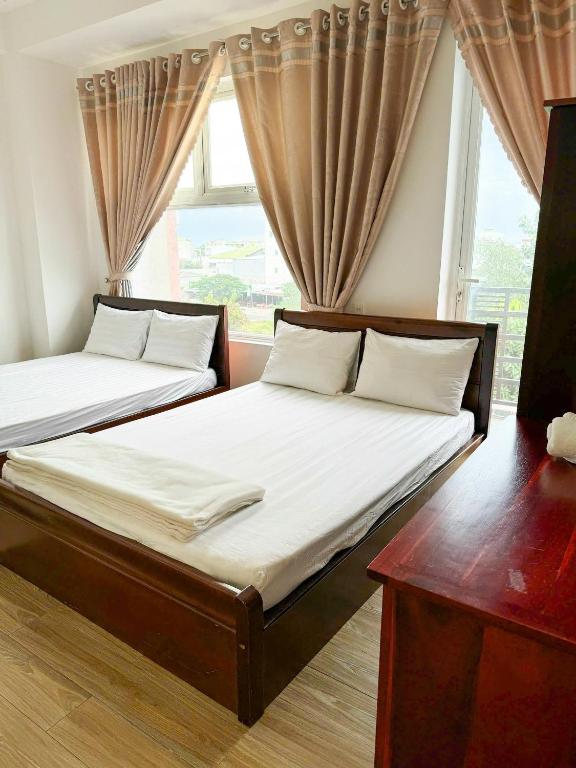 Postel nebo postele na pokoji v ubytování Minh Trang Motel