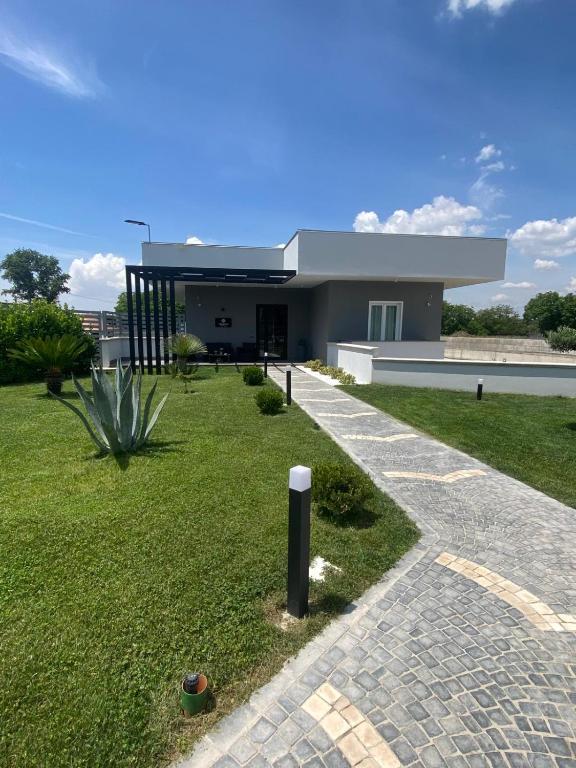 a house with a walkway in front of it at Brahma luxury B&B in Marigliano