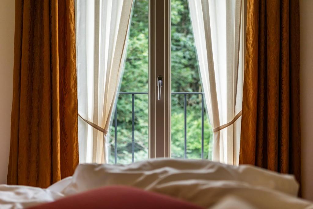 Postel nebo postele na pokoji v ubytování Hotel Cortese
