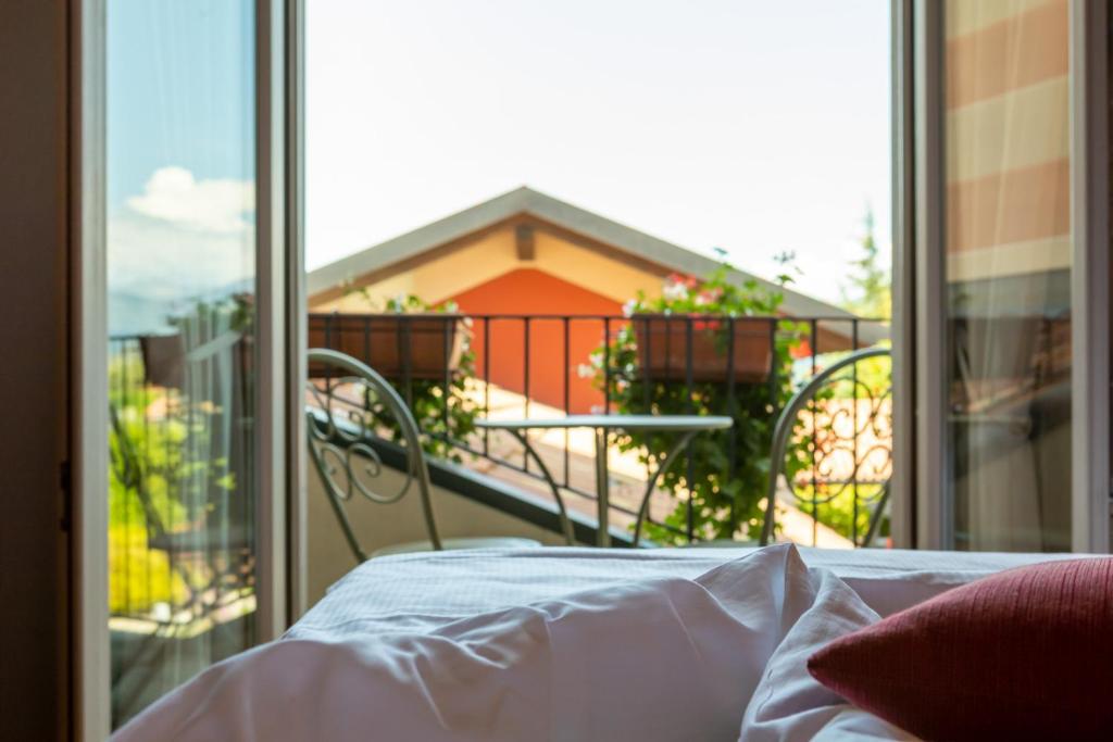 Postel nebo postele na pokoji v ubytování Hotel Cortese
