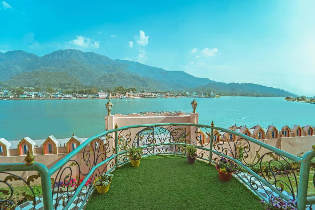 a balcony with a view of a body of water at The Neeraj Ganga Heritage Palace in Rishīkesh