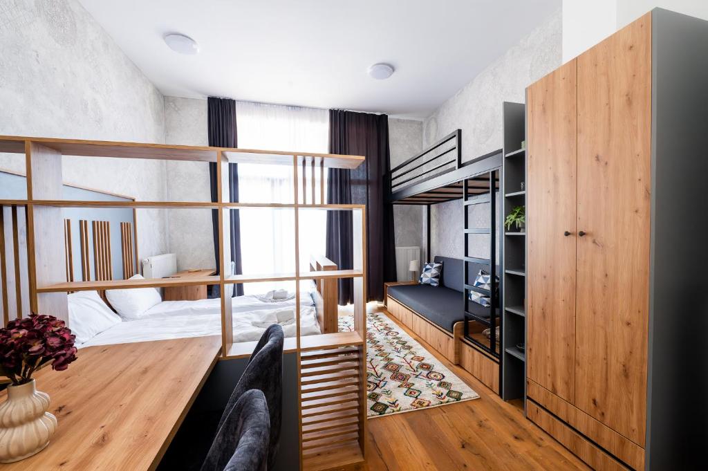 a bedroom with a bunk bed and a desk at Mountain Magic Bjelašnica in Bjelašnica