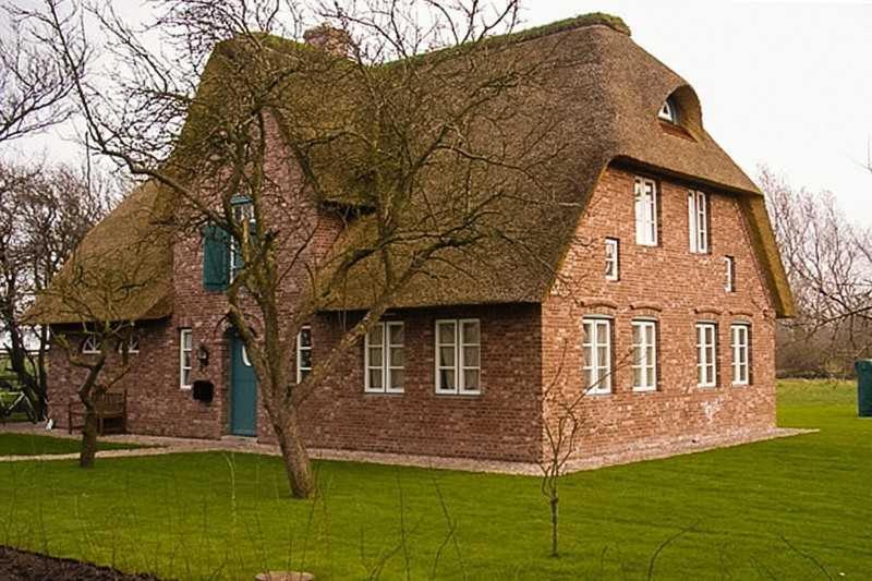 une grande maison en briques rouges avec un toit à la mansarde dans l'établissement Föhrhaus, Einzelhaus, Knickrehm, à Oldsum