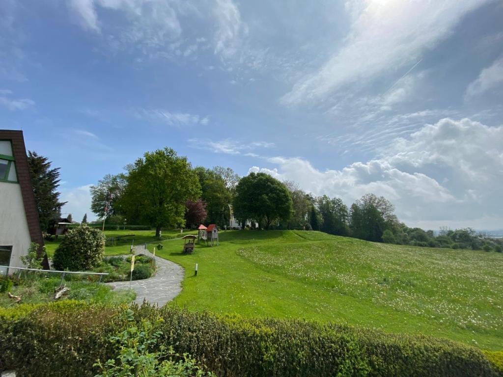 a grassy field with a path in the middle at Schönstattzentrum Aulendorf in Aulendorf